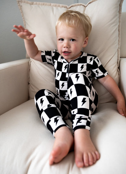 Bamboo boy and girl pajama set with checkers and lightning bolts.