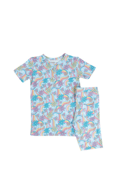 Bamboo pajama set for toddler girls in groovy, hippie, 70’s style print with mushrooms and florals on it. Button down collar and back pocket and the bamboo fabric is hypoallergenic, temperature regulating and is moisture wicking. 