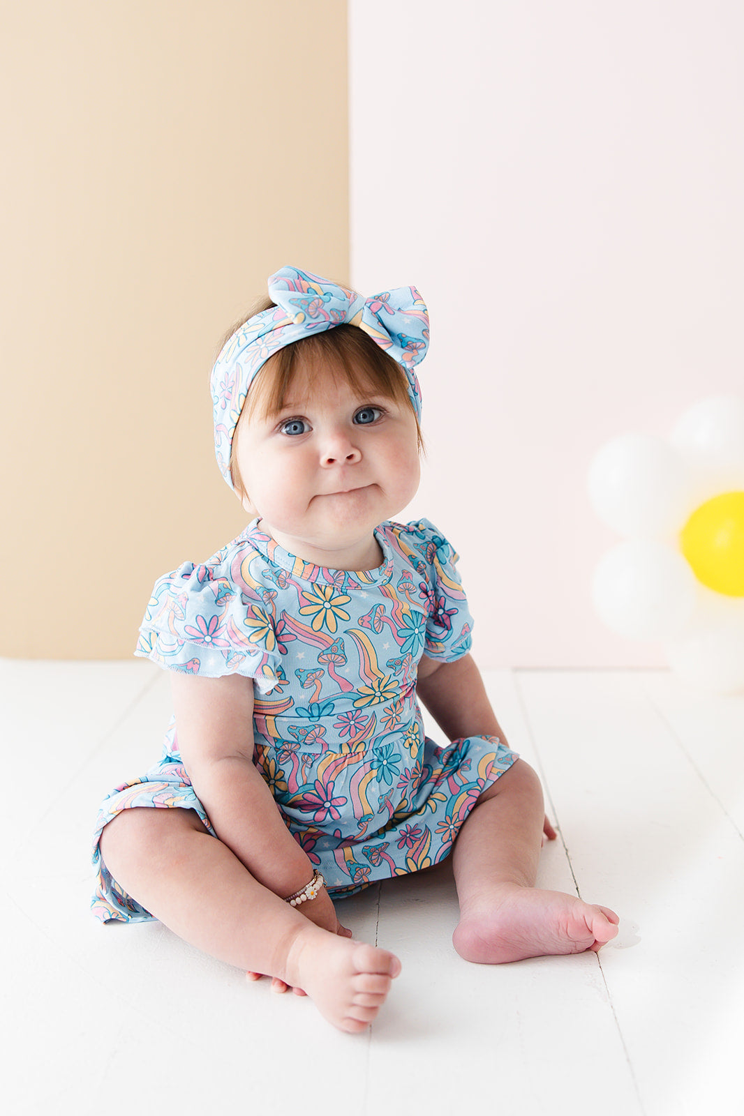 Bamboo bow and head wrap for baby girl in floral, groovy, hippie, 70’s print with flowers, mushrooms and stripes.