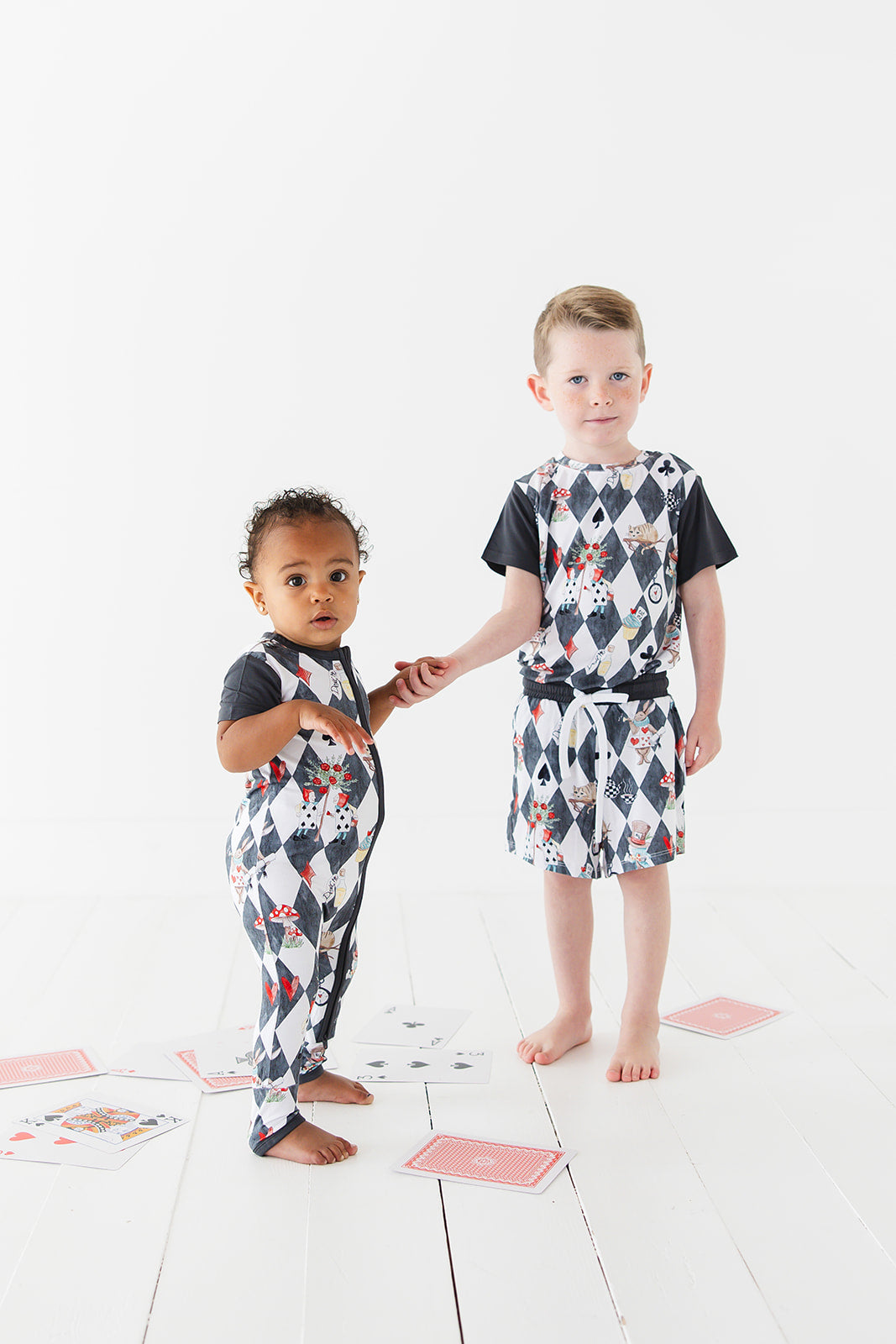 Short sleeve, double zipper romper for baby boys and girls. Gender neutral bamboo romper in Alice in Wonderland print.