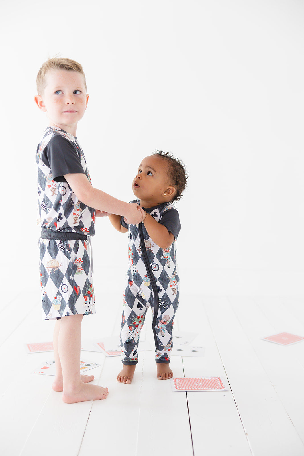 Short sleeve, double zipper romper for baby boys and girls. Gender neutral bamboo romper in Alice in Wonderland print.