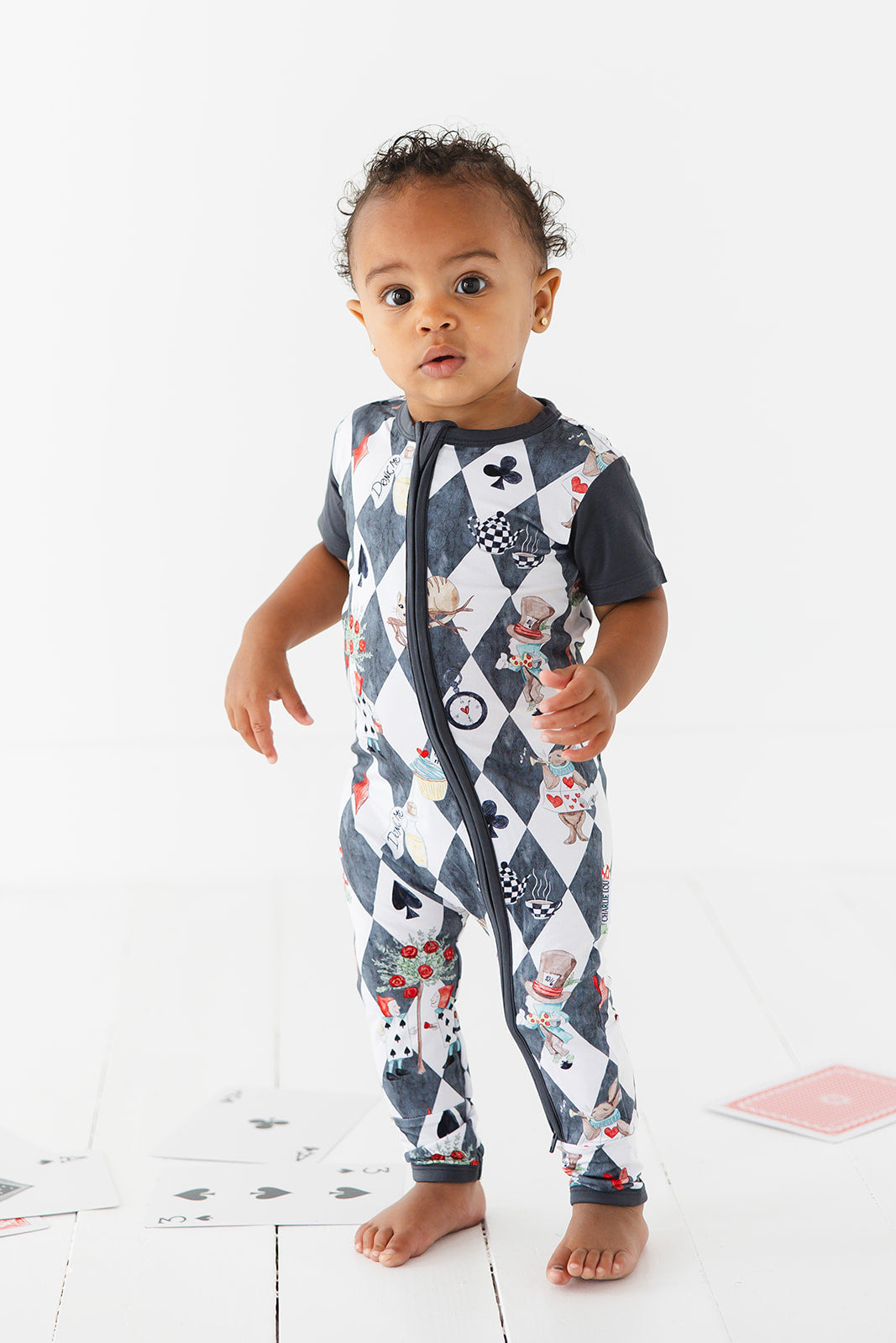 Short sleeve, double zipper romper for baby boys and girls. Gender neutral bamboo romper in Alice in Wonderland print.