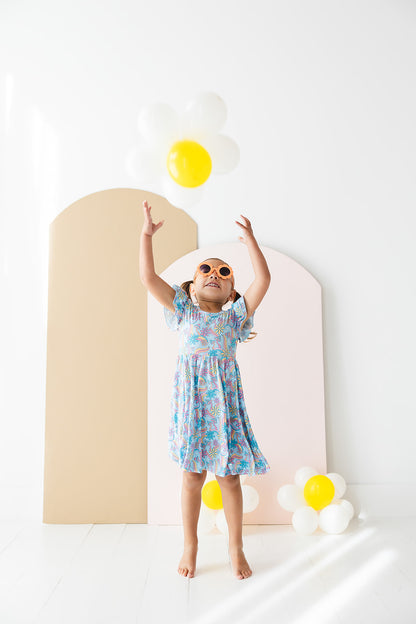 Bamboo twirl dress for baby girls and toddlers with mushrooms and florals.