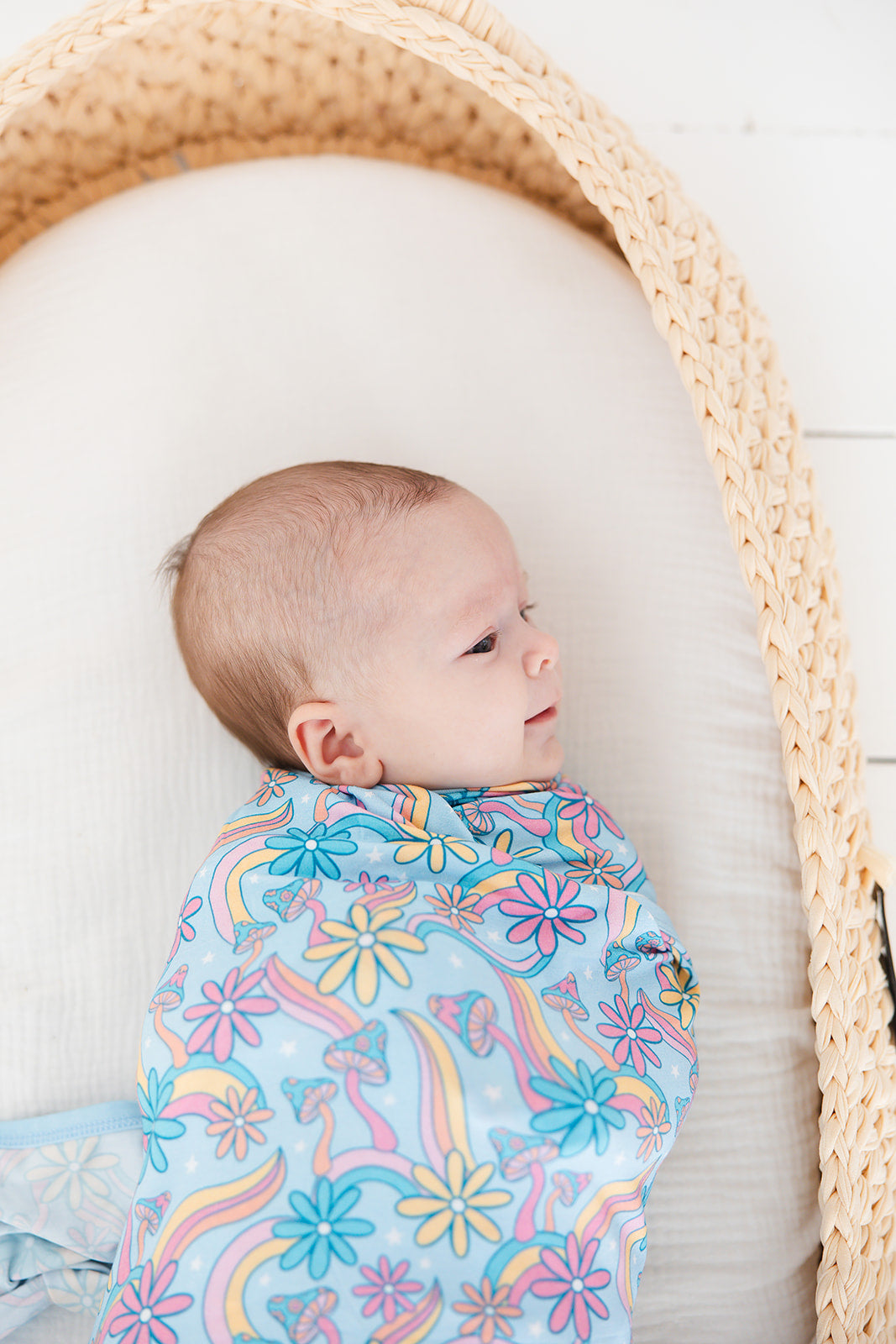 Bamboo swaddle with florals and mushrooms for baby girl. Hippie, groovy, 70’s style stretchy and soft swaddle.