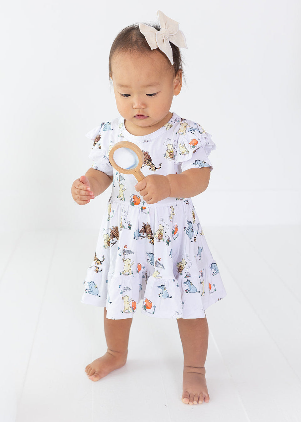 Little girl Winnie the Pooh bamboo twirl dress with matching shorts for Fall.