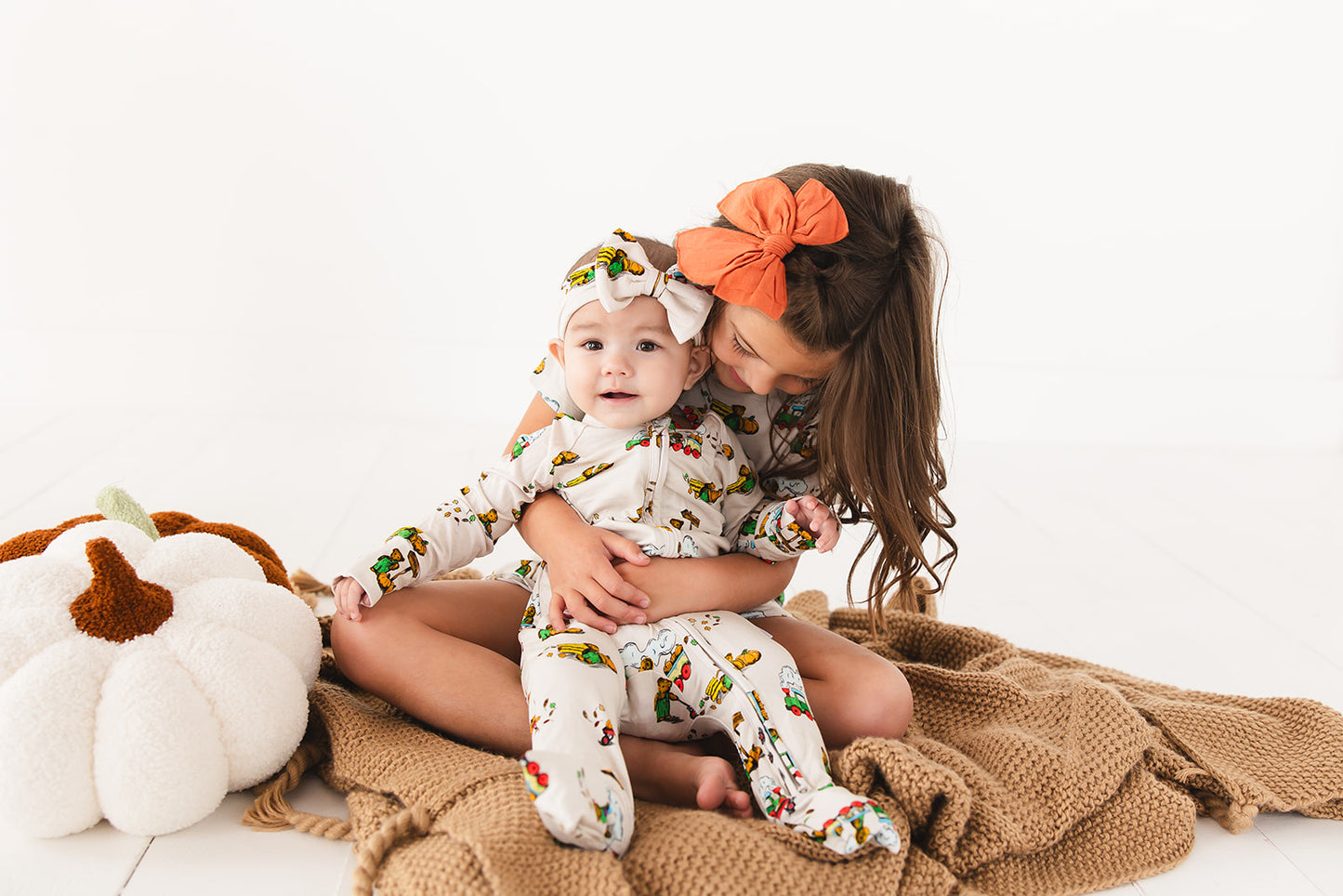 Bamboo convertible romper with hand and foot cuffs in Corduroy book print for baby boys and girls.