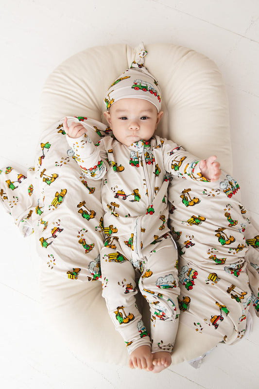 Bamboo convertible romper with hand and foot cuffs in Corduroy book print for baby boys and girls.