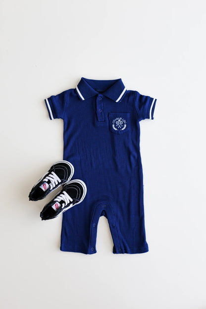 Preppy boys short sleeve polo romper with crotch snaps made from blue waffle bamboo & embroidered with Charlie Lou Baby Club.