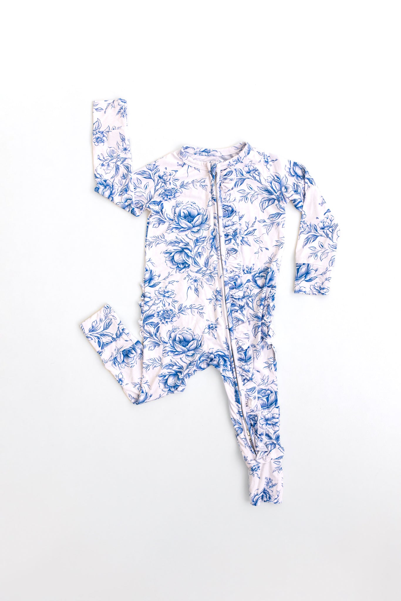 Bamboo zippy with ruffles with blue floral toile print for baby girl with double zippers and hand and foot cuffs.