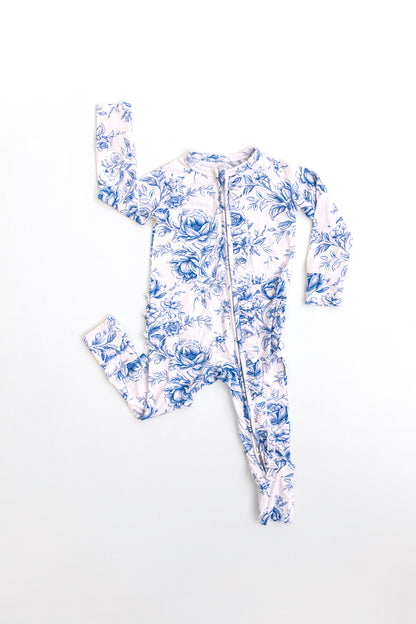 Bamboo zippy with ruffles with blue floral toile print for baby girl with double zippers and hand and foot cuffs.