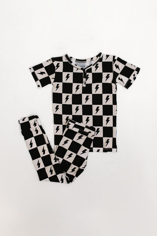 Bamboo boy and girl pajama set with checkers and lightning bolts.