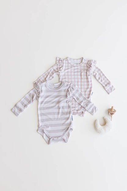 Ruffle bamboo bodysuit with crotch snaps and hand cuffs in peach and pink gingham.