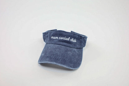 Washed and vintage style visor which is blue with words mom social club on it.