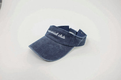 Washed and vintage style visor which is blue with words mom social club on it.