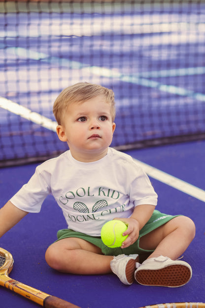 Gender neutral athletic green sports shorts for baby and toddler boys and girls.