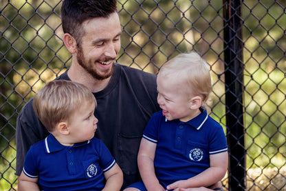 Preppy boys short sleeve polo romper with crotch snaps made from blue waffle bamboo & embroidered with Charlie Lou Baby Club.