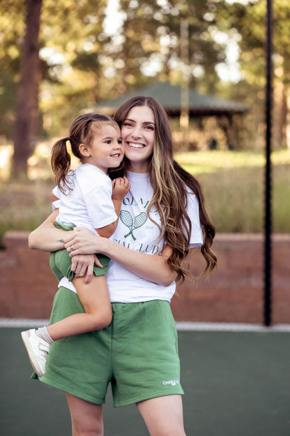 Cool Kid Club white T-Shirt with green graphic which is gender neutral for boys and girls with shoulder snaps.