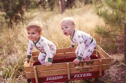 Gender neutral bamboo pajama set in golf sports print with green cuffs for toddler boys and girls.