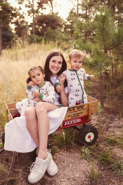 Gender neutral bamboo pajama set in golf sports print with green cuffs for toddler boys and girls.