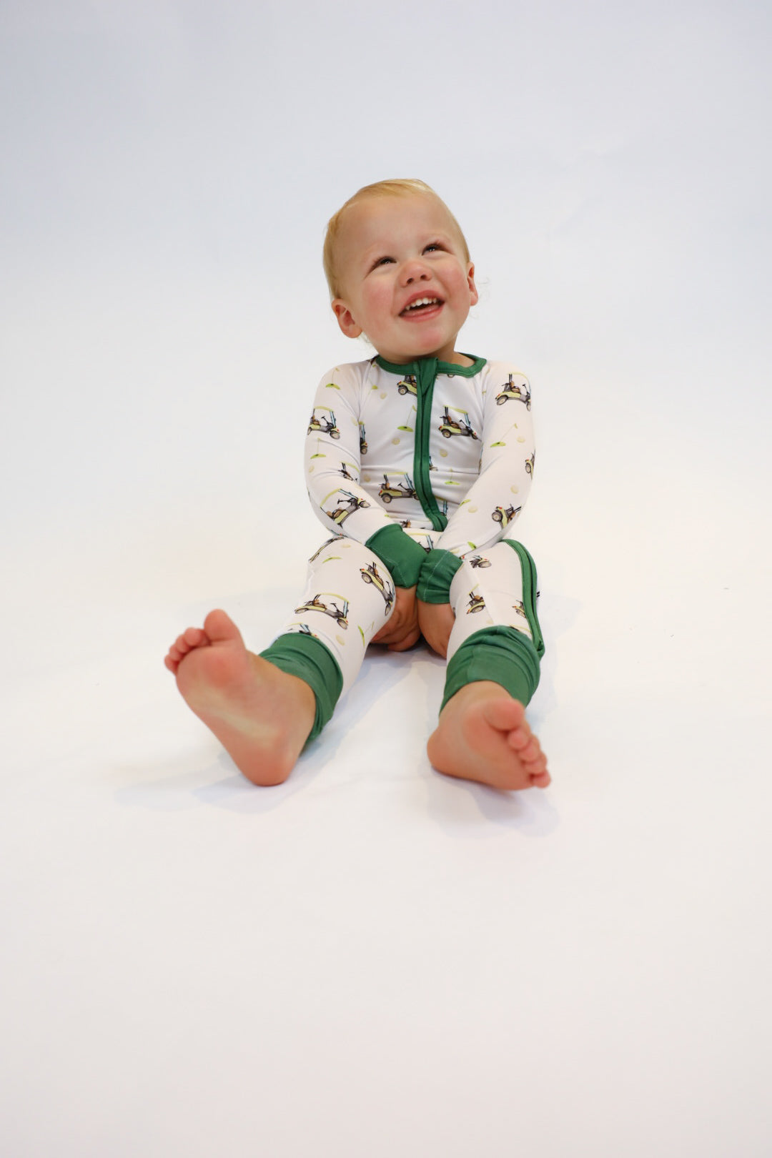 Double zipper baby romper with convertible hand & foot cuffs made from bamboo with green golf sports print for boys or girls.