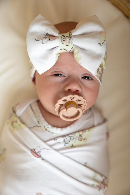 Bamboo baby bow with a Winnie the Pooh design.