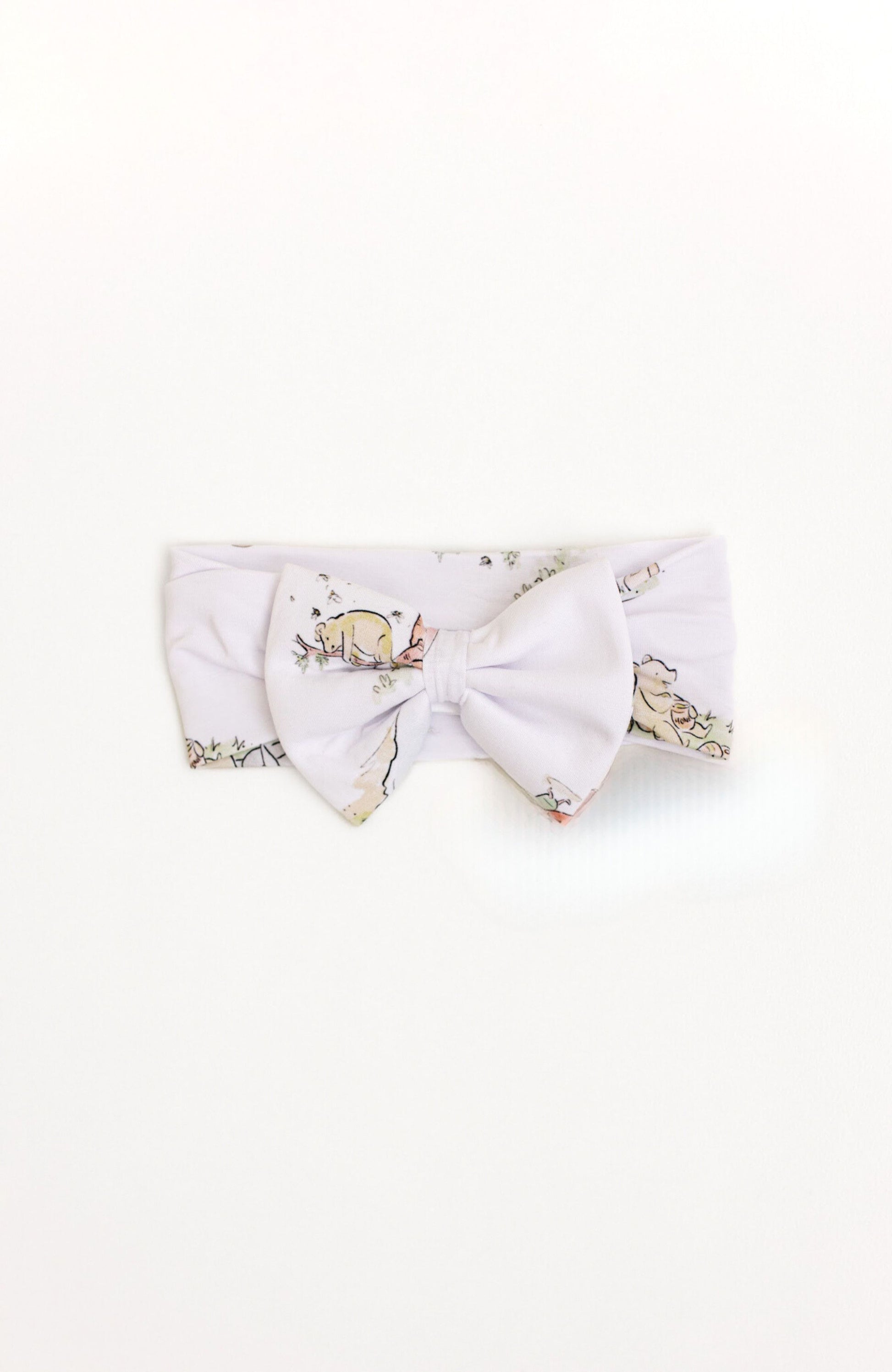 Bamboo baby bow with a Winnie the Pooh design.