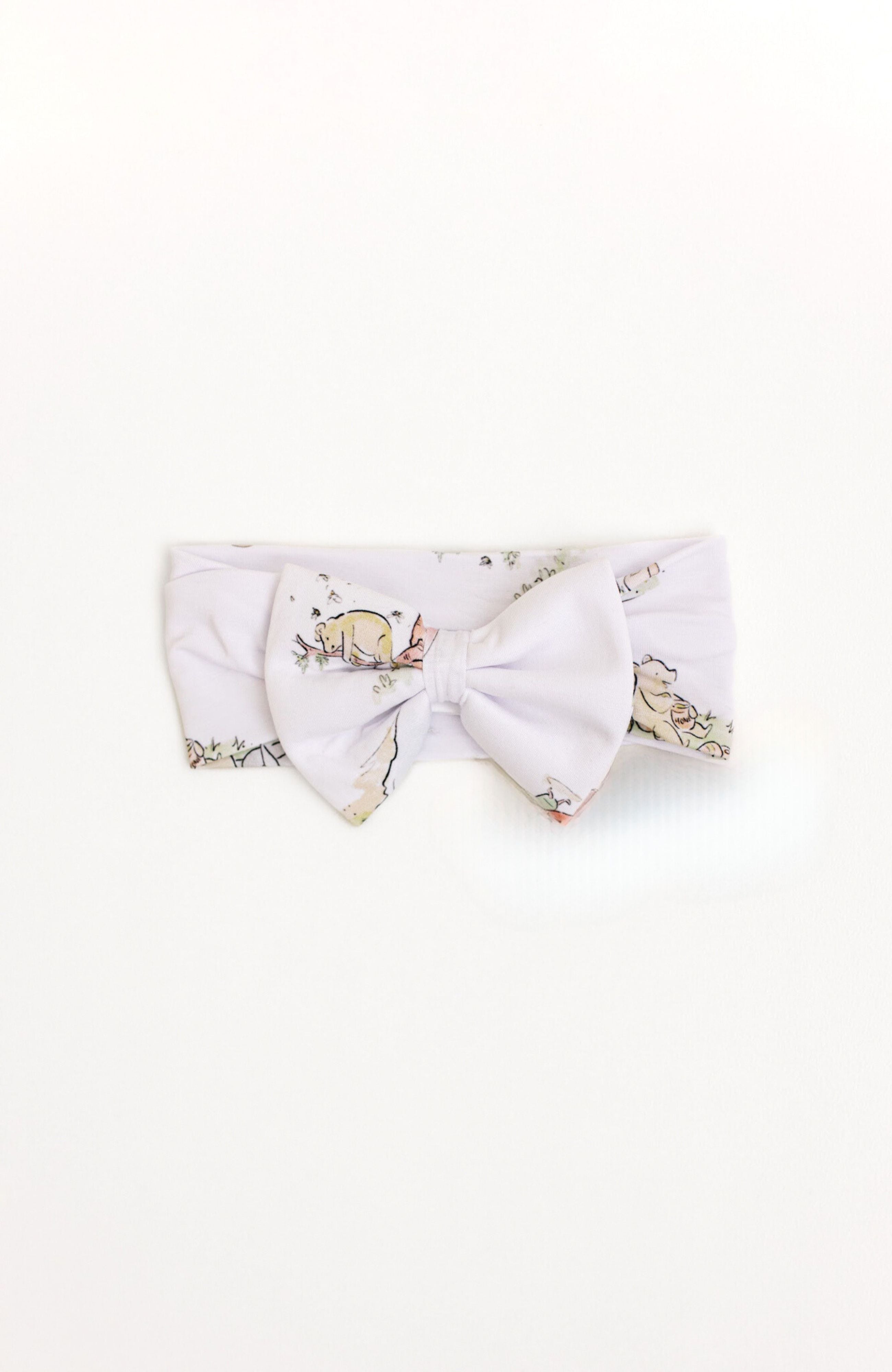Bamboo baby bow with a Winnie the Pooh design.