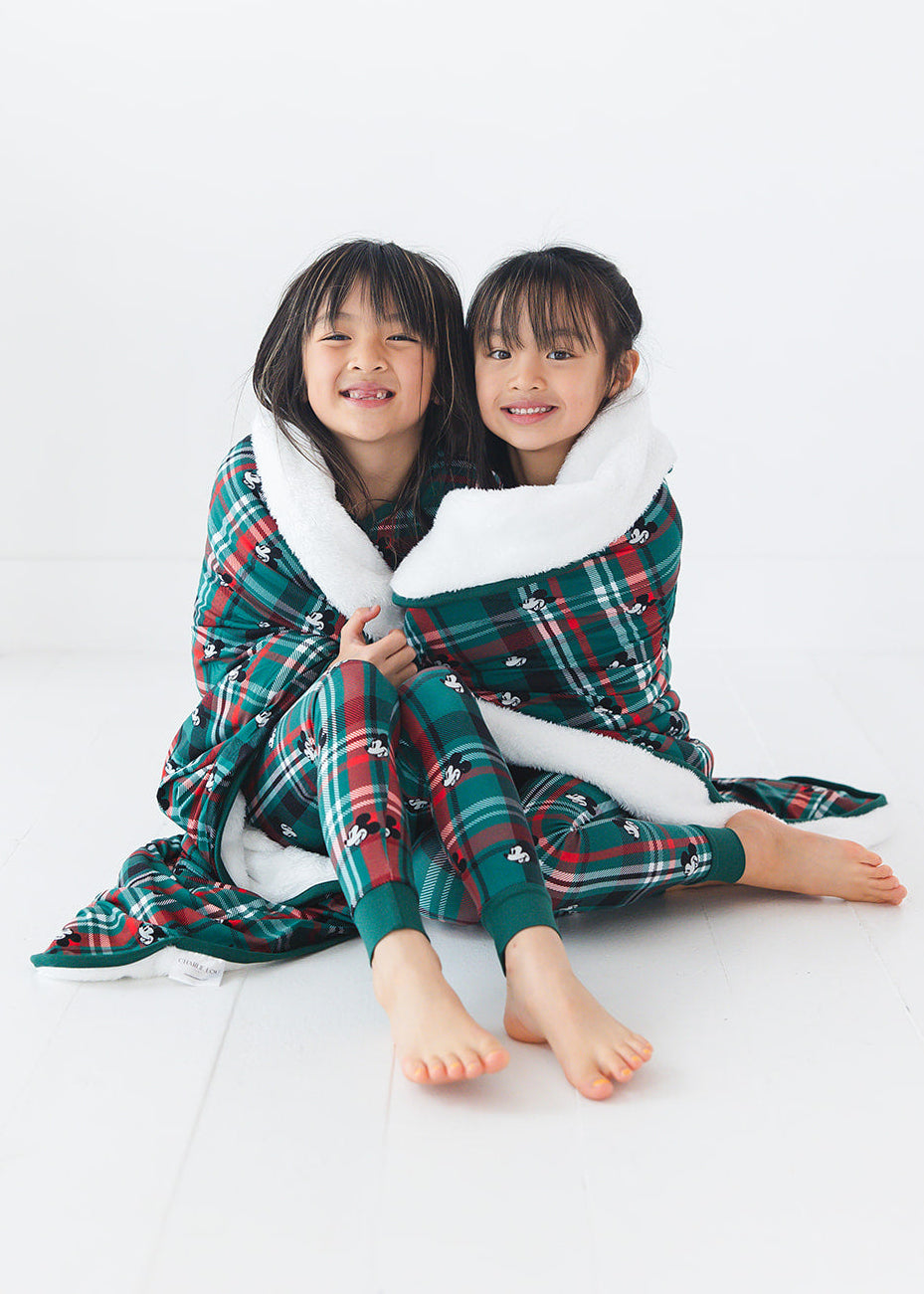 Green and red tartan bamboo plush blanket in Christmas Disney Mickey print.