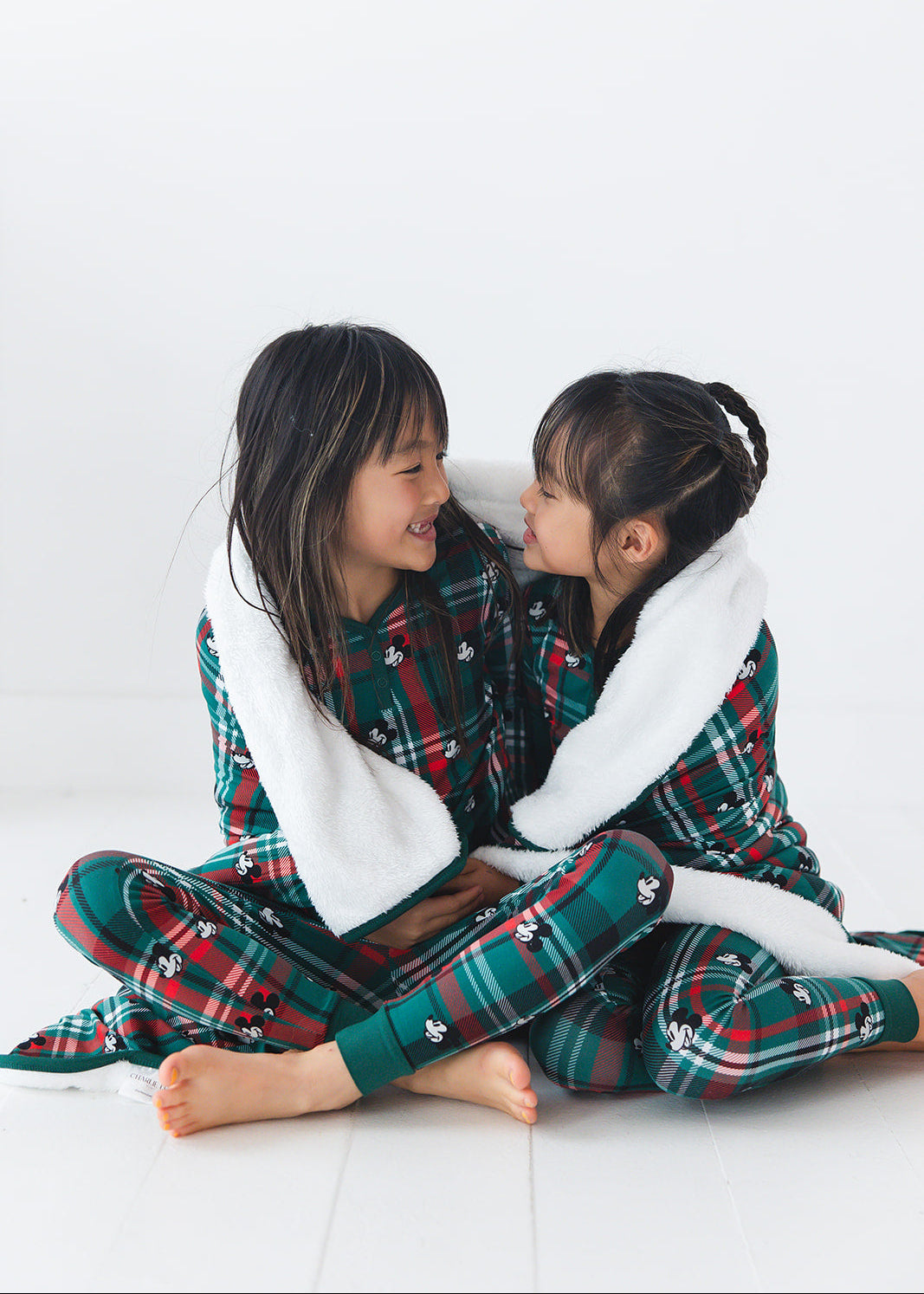 Green and red tartan bamboo plush blanket in Christmas Disney Mickey print.