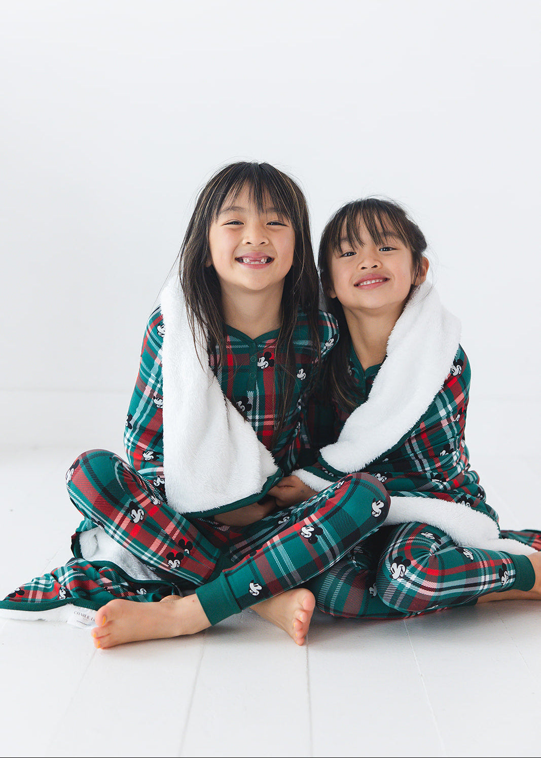 Green and red tartan bamboo plush blanket in Christmas Disney Mickey print.