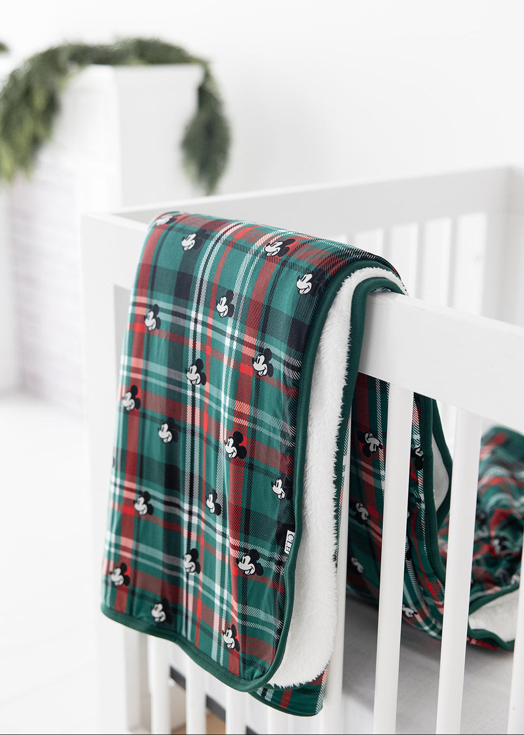 Green and red tartan bamboo plush blanket in Christmas Disney Mickey print.