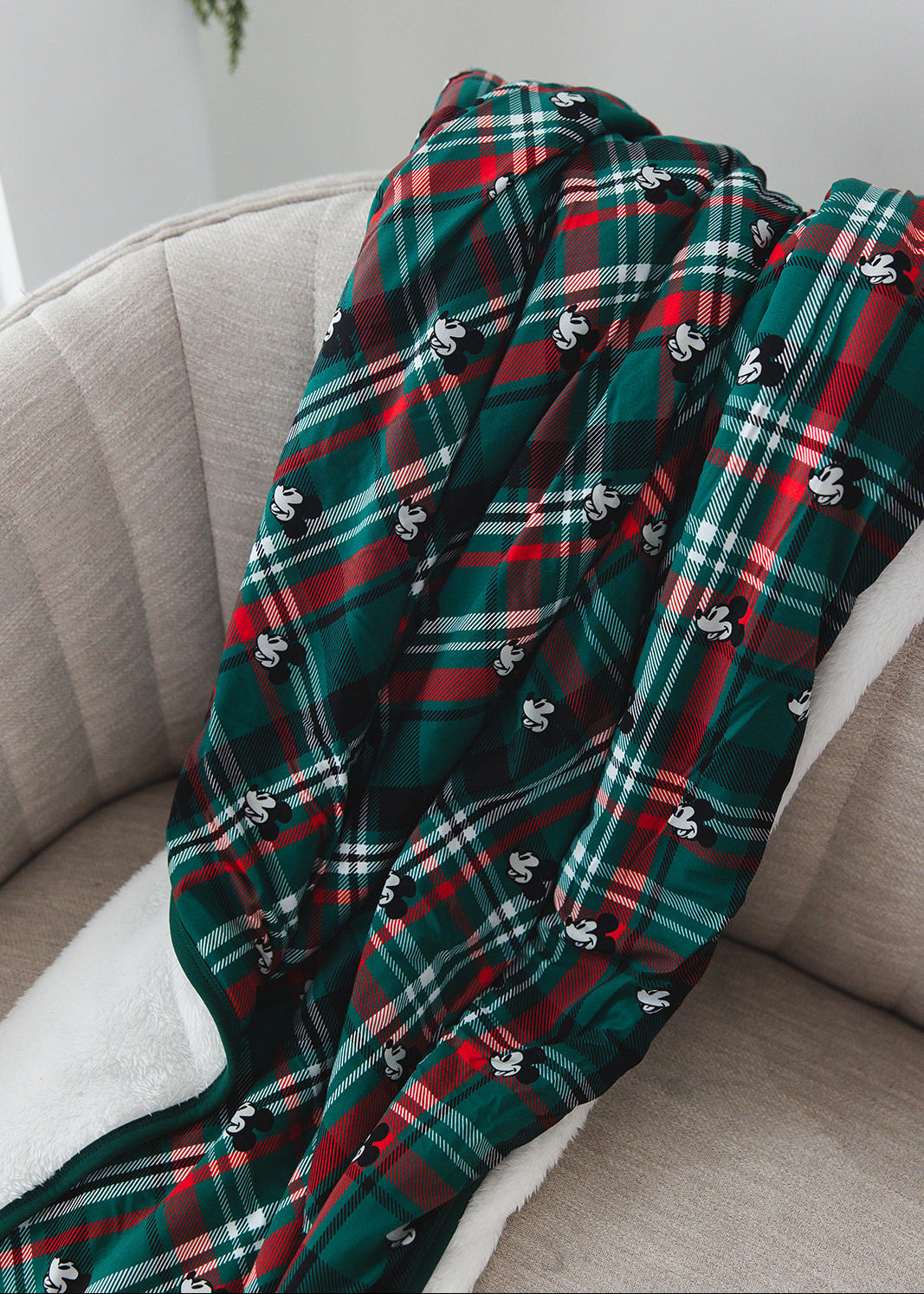 Green and red tartan bamboo plush blanket in Christmas Disney Mickey print.