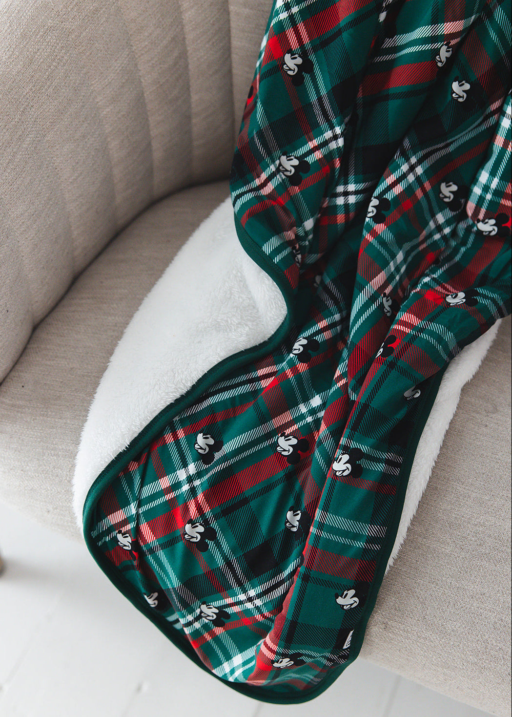Green and red tartan bamboo plush blanket in Christmas Disney Mickey print.