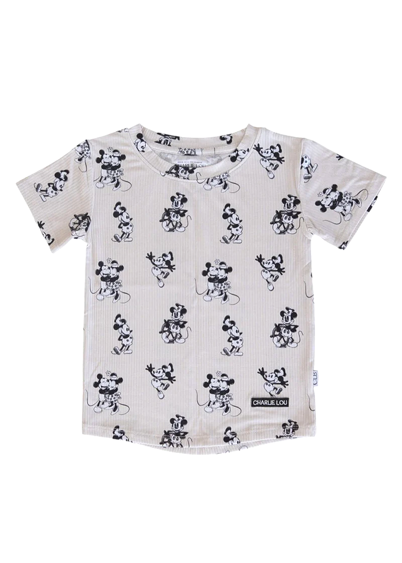 Child wearing a white t-shirt with black steamboat willie print on a white background