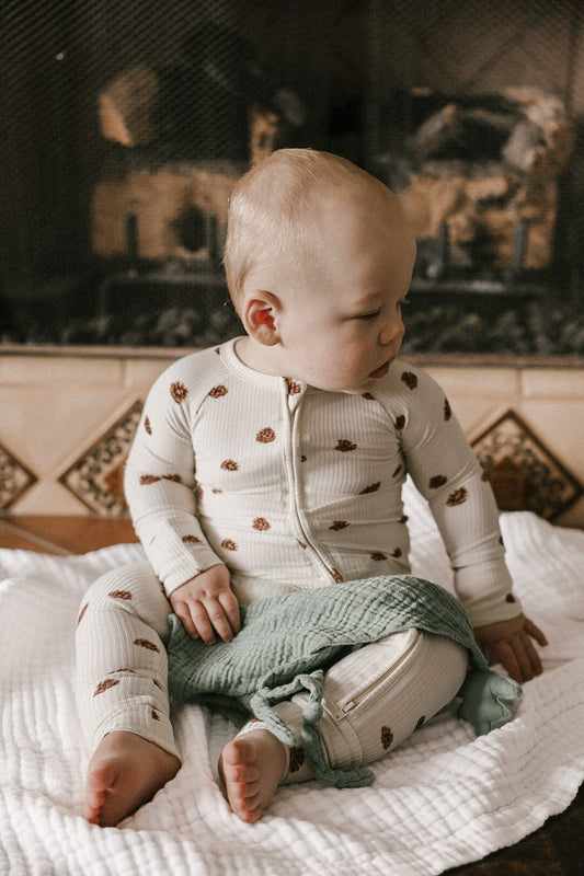 Double zipper baby romper with convertible hand & foot cuffs made from bamboo with winter pinecone print for boys or girls.