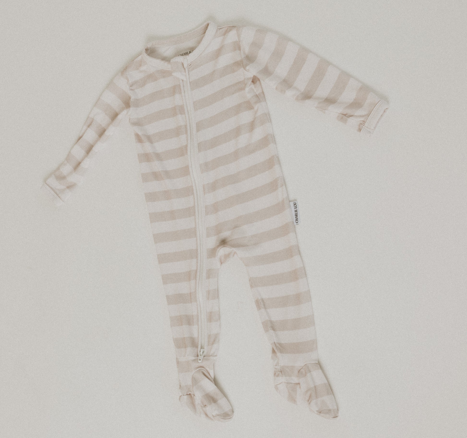 Gender neutral striped bamboo footed pajamas with double zipper.